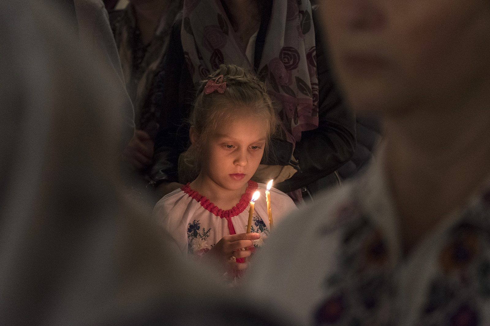 A young girl dressed in traditional Ukrainian attire attends Orthodox Easter Mass, Sunday, April 24, 2022, in Bucharest, Romania. RNS photo by Alexandra Radu