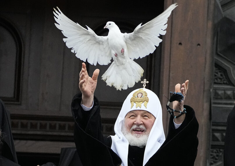 Russian Orthodox Church Patriarch Kirill releases a bird celebrating the Annunciation preceding the celebration of Orthodox Easter in front of the Christ the Savior Cathedral in Moscow, Russia, Thursday, April 7, 2022. (AP Photo/Alexander Zemlianichenko)