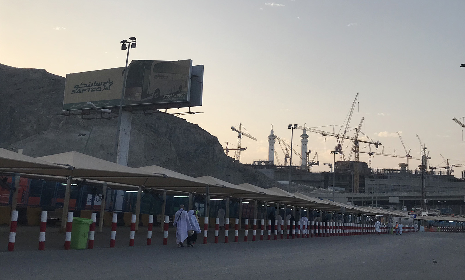Pilgrims walk to the Grand Mosque one morning in mid-April, 2022, in Mecca, Saudi Arabia. A Grand Mosque expansion project can be seen in the background. Photo by Rabiya Jaffery