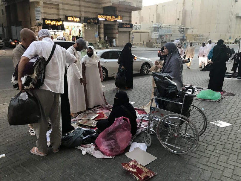 Umrah pilgrims peruse items offered by street vendors in Mecca, Saudi Arabia, during Ramadan in mid-April 2022. Photo by Rabiya Jaffery