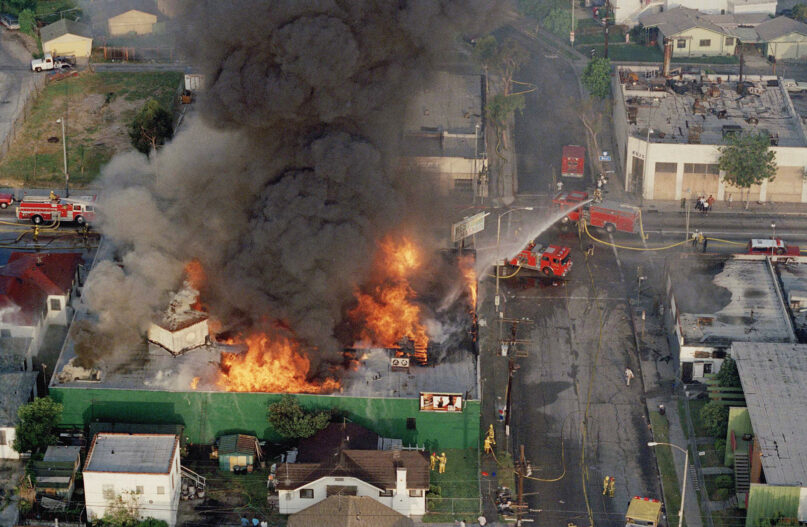 In this April 30, 1992, file photo, a fire burns out of control at the corner of 67th Street and West Boulevard in South Central Los Angeles. On April 29, 1992, white police officers were declared innocent in the beating of Black motorist Rodney King, and Los Angeles erupted in deadly riots. (AP Photo/Paul Sakuma)