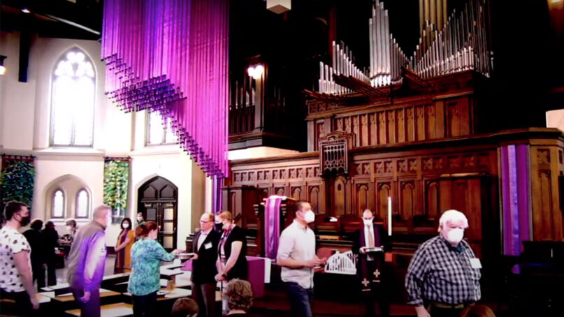 Communion is served during the March 6, 2022, service at First United Church of Oak Park in Chicago. Video screen grab