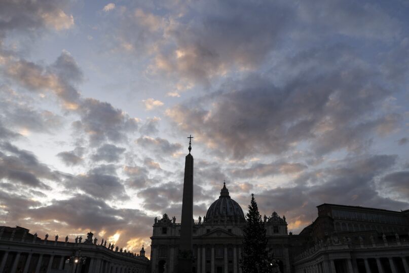 The sun sets behind St. Peter’s Basilica, at the Vatican, Dec. 5, 2019. The Vatican’s sprawling financial trial may not have produced any convictions yet or any new smoking guns. But recent testimony in May 2022 has provided plenty of insights into how the Vatican operates. (AP Photo/Gregorio Borgia, File)