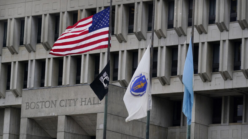 The American flag, the Commonwealth of Massachusetts flag, and the City of Boston flag, from left, fly outside Boston City Hall, Monday, May 2, 2022, in Boston. A unanimous Supreme Court has ruled that Boston violated the free speech rights of a conservative activist when it refused his request to fly a Christian flag on a flagpole outside City Hall. Justice Stephen Breyer wrote for the court Monday that the city discriminated against the activist because of his 