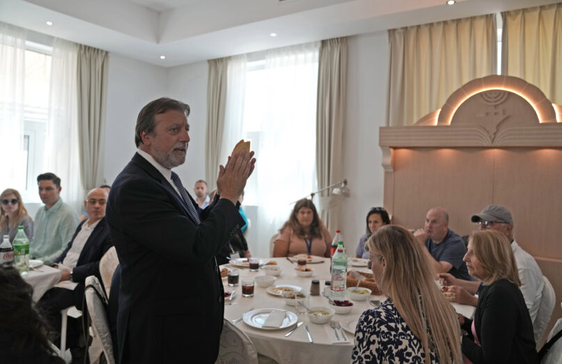 Rabbi Elie Abadie says a blessing as he hosts a lunch for a Jewish business delegation at a villa that serves as a temporary synagogue for his congregation in Dubai, United Arab Emirates, Tuesday, May 10, 2022. The fast-growing population of Jewish immigrants to the United Arab Emirates may feel freer than ever to express their identity in the autocratic Arab sheikhdom, which has sought to brand itself as an oasis of religious tolerance. But plans to build a permanent Jewish sanctuary for Dubai’s fast-expanding congregation have sputtered to a standstill, religious leaders say. (AP Photo/Kamran Jebreili)