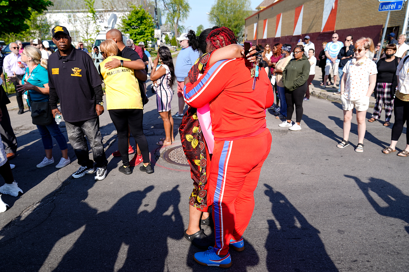 People embrace outside the scene of a shooting at a supermarket in Buffalo, New York, Sunday, May 15, 2022. (AP Photo/Matt Rourke)