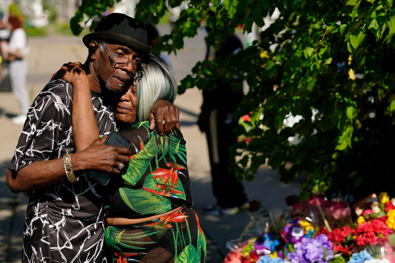 People embrace outside the scene of a shooting at a supermarket a day earlier, in Buffalo, N.Y., Sunday, May 15, 2022. (AP Photo/Matt Rourke)