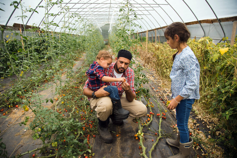 Samer Saleh with his children in a greenhouse at Halal Pastures Farm in Rock Tavern, New York. Photo courtesy Halal Pastures