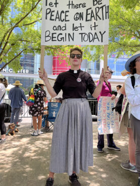 The Rev. Ashleigh Dellagiacoma, a Lutheran pastor in Houston, demonstrates across the street from the National Rifle Association annual meeting held at the George R. Brown Convention Center, Friday, May 27, 2022, in Houston. RNS photo by Katherine Keenan