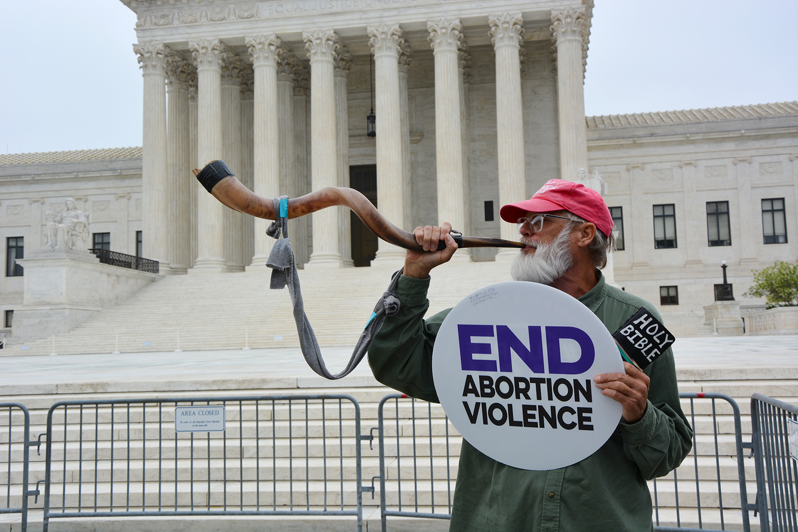 Steve Corson blows a shofar in front of the U.S. Supreme Court, Tuesday, May 3, 2022, in Washington. RNS photo by Jack Jenkins