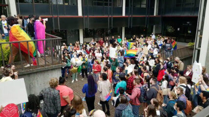 People demonstrate at Seattle Pacific University, Tuesday, May 24, 2022, after the board of trustees recently decided to retain a policy that prohibits the hiring of LGBTQ people.  Video screenshot via Twitter/Jeanie Lindsay