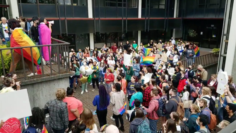 People demonstrate at Seattle Pacific University, May 24, 2022, after the board of trustees recently decided to retain a policy that prohibits the hiring of LGBTQ people. Video screen grab via Twitter/Jeanie Lindsay