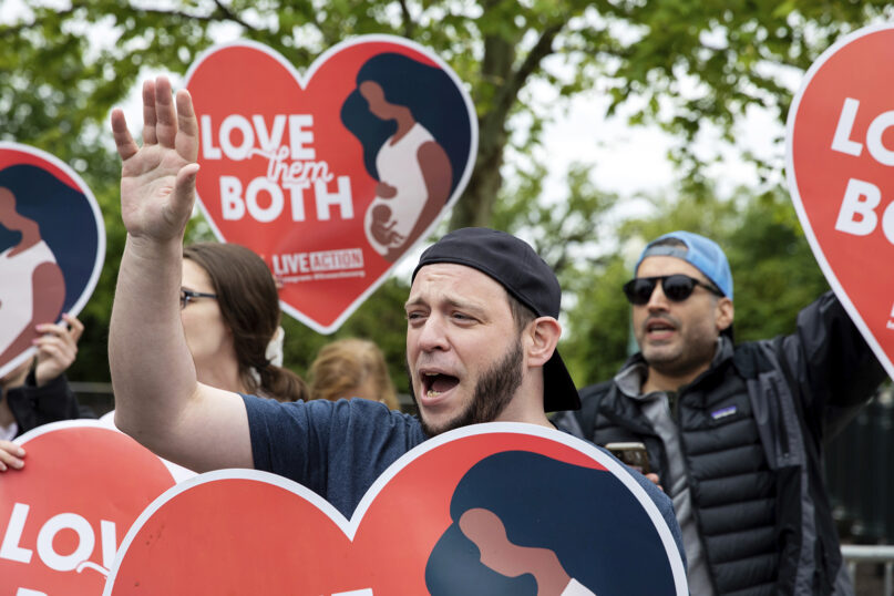 Anti-abortion protesters hold signs during a demonstration outside of the U.S. Supreme Court in Washington, Sunday, May 8, 2022. (AP Photo/Amanda Andrade-Rhoades)