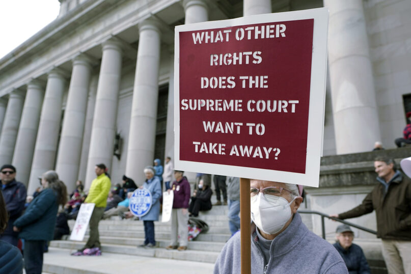 A person holds a sign referencing the U.S. Supreme Court while taking part in a rally in favor of abortion rights on the steps of the Temple of Justice, which houses the Washington state Supreme Court, May 3, 2022, at the Capitol in Olympia, Washington. (AP Photo/Ted S. Warren)