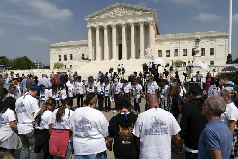 A Christian group prays outside of the U.S. Supreme Court, May 3, 2022, in Washington. (AP Photo/Jose Luis Magana)
