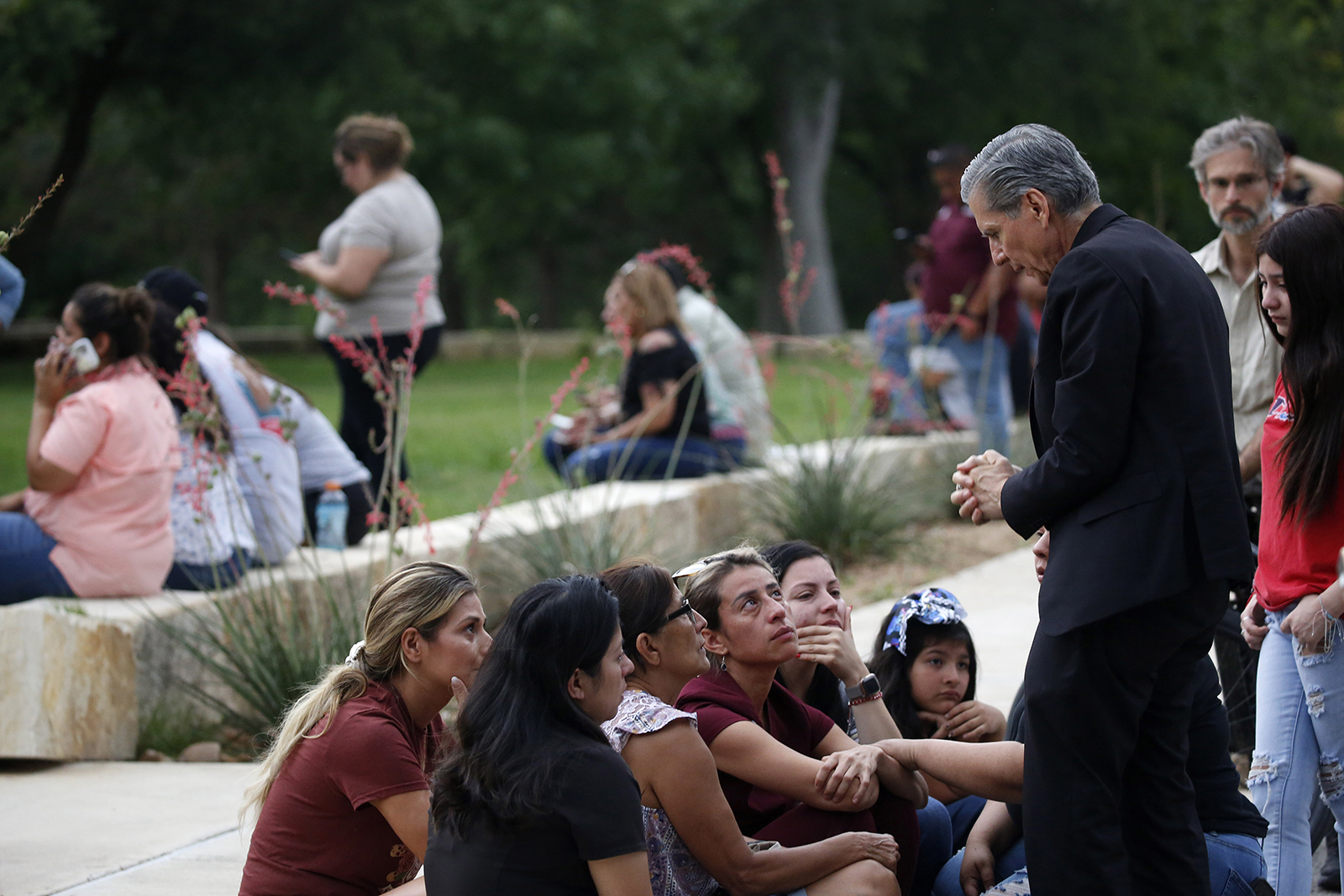 The archbishop of San Antonio, Gustavo Garcia-Siller, right, comforts families outside the Civic Center following a deadly school shooting at Robb Elementary School in Uvalde, Texas, Tuesday, May 24, 2022. (AP Photo/Dario Lopez-Mills)