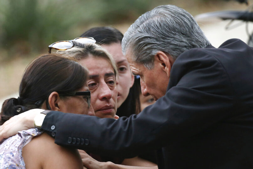 The archbishop of San Antonio, Gustavo García-Siller, comforts families outside the Civic Center after a deadly school shooting at Robb Elementary School in Uvalde, Texas, May 24, 2022. (AP Photo/Dario Lopez-Mills)