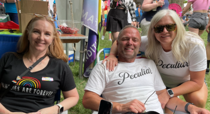Greg Deussen and Alyson Paul, founders of Peculiar, at the Utah Pride Festival with friend Jana Spangler, June 5, 2022. Spangler is wearing a "Families Are Forever" tee-shirt that references both a common LDS theme and the LGBTQ rainbow. RNS photo by Jana Riess