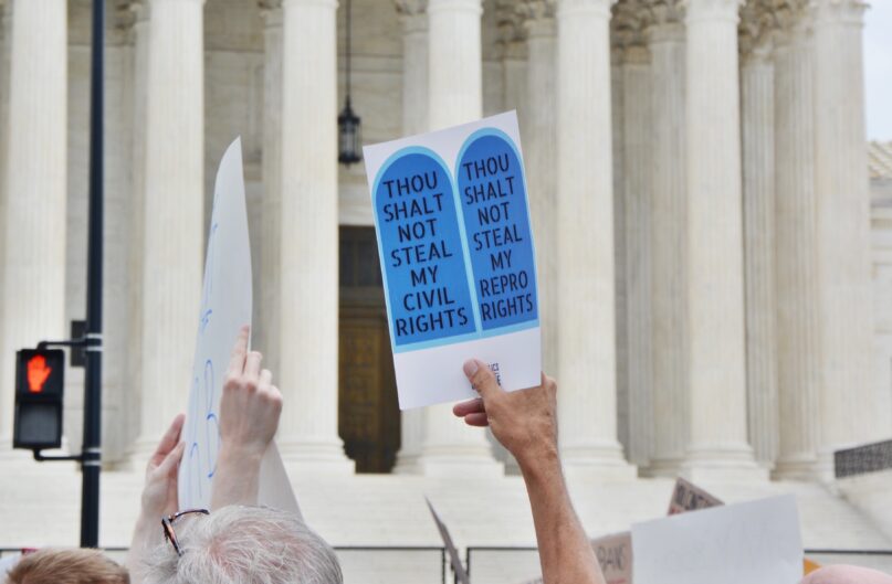 A demonstrator holds a sign outside the Supreme Court on June 24, 2022. RNS photo by Jack Jenkins