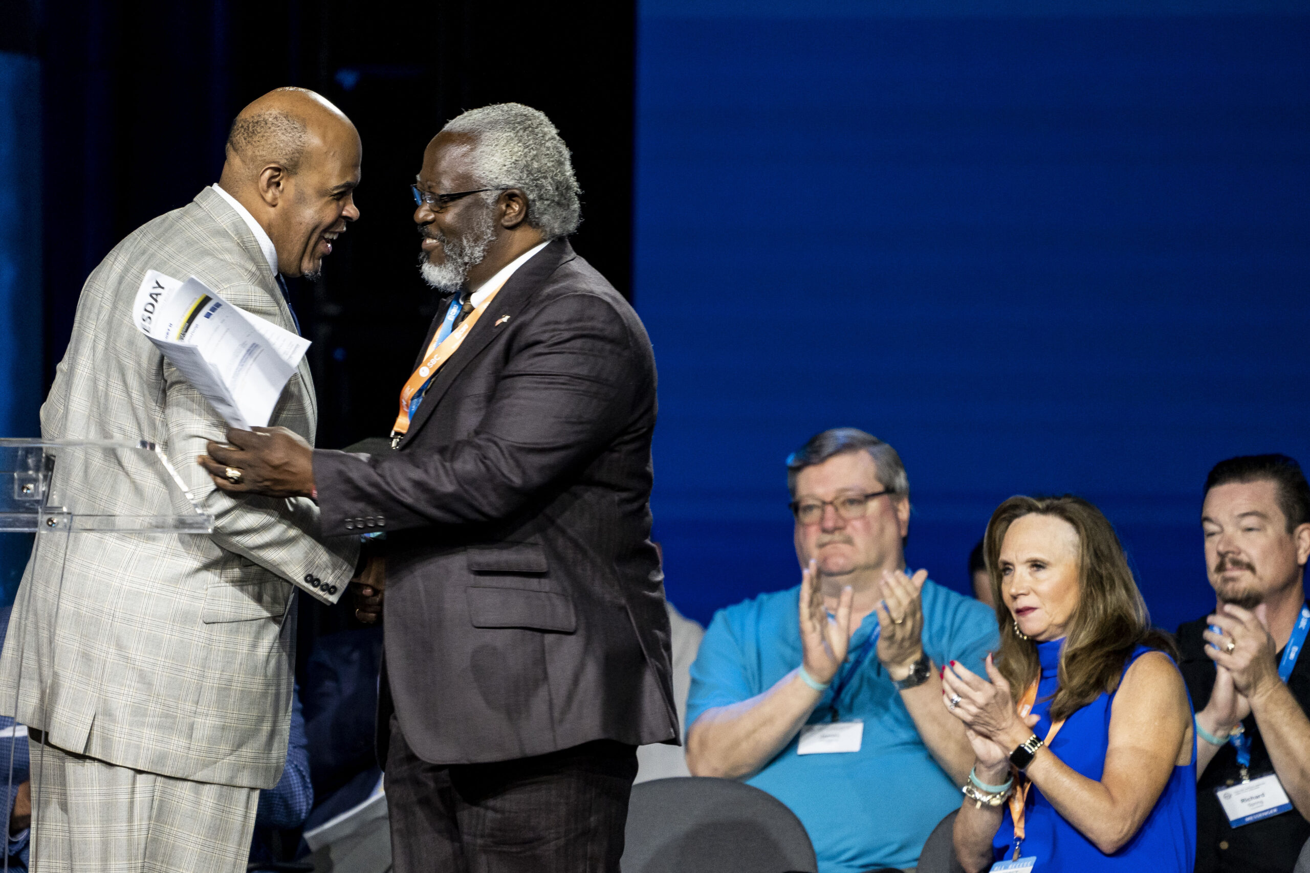 Willie D. McLaurin welcomes Rolland Slade to the podium at the Southern Baptist Convention annual meeting, held at the Anaheim Convention Center in Anaheim, California, on Wednesday, June 15, 2022. Photo by Justin L. Stewart/Religion News Service