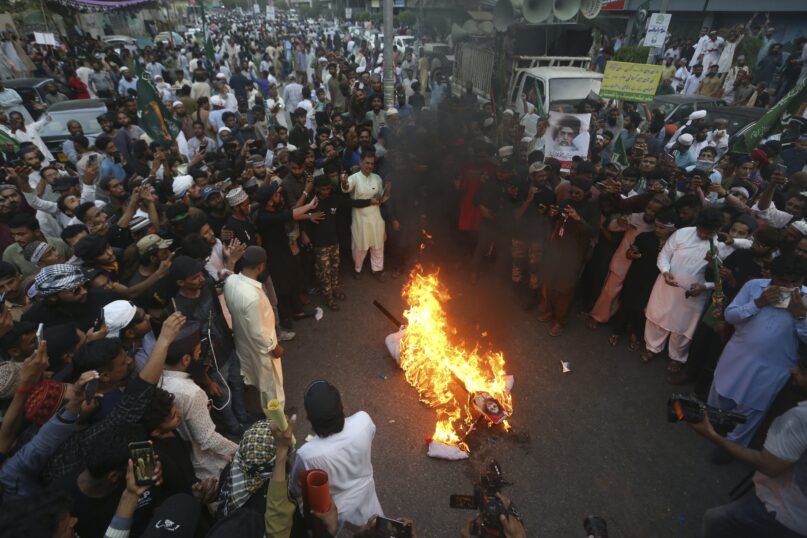 Supporters of a Pakistani religious group burn an effigy depicting the former spokeswoman of India's ruling party, Nupur Sharma, during a demonstration in Karachi, Pakistan. (AP Photo/Fareed Khan)