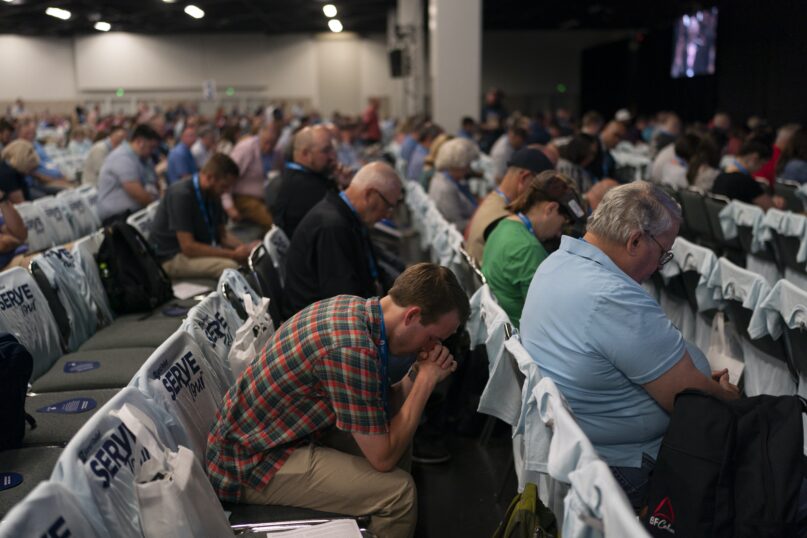 Attendees pray during a worship service at the Southern Baptist Convention annual meeting in Anaheim, California, on June 14, 2022. (AP Photo/Jae C. Hong)