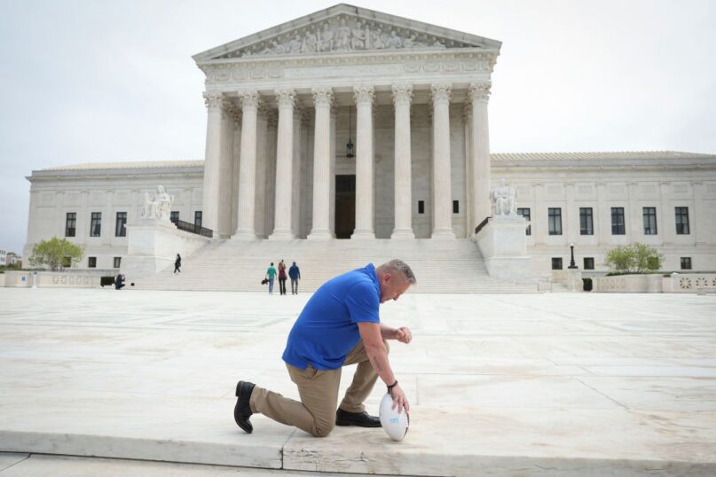 Joe Kennedy poses in front of the U.S. Supreme Court building after his legal case, Kennedy v. Bremerton School District, was argued before the court on April 25, 2022. (Win McNamee/Getty Images News via Getty Images)