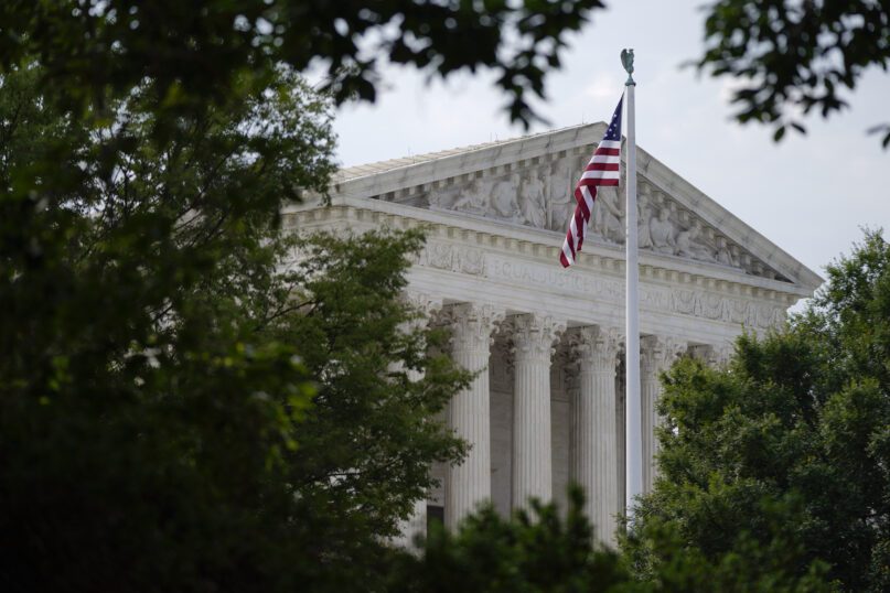 An American flag waves in front of the U.S. Supreme Court building, June 27, 2022, in Washington. (AP Photo/Patrick Semansky)