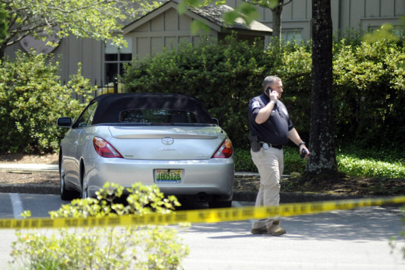 A police officer walks outside St. Stephen's Episcopal Church in Vestavia Hills, Ala., on Friday, June 17, 2022. Authorities say two people were shot to death and a third was wounded during an evening gathering when a man pulled out a handgun and began firing. (AP Photo/Jay Reeves)