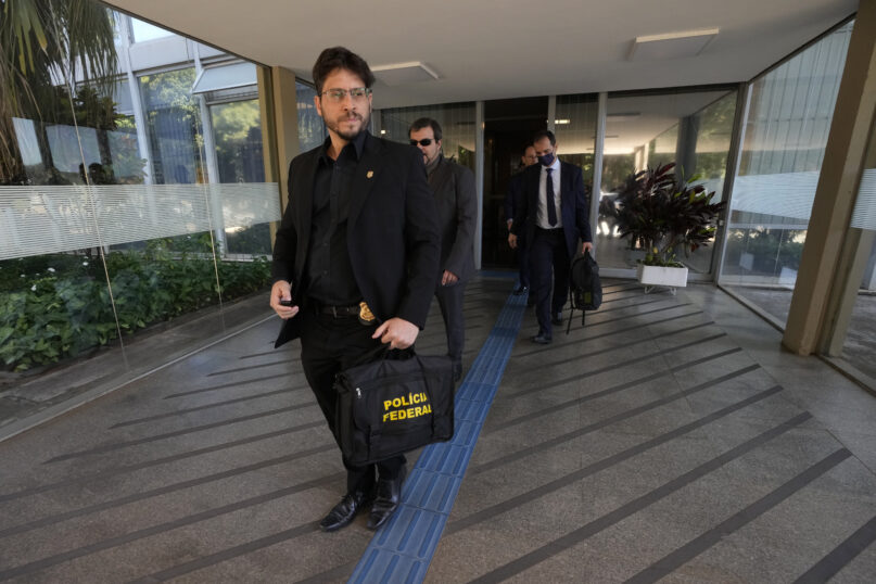 Federal police leave the headquarters of the Education Ministry after searching for evidence connected to the work of former Education Minister Milton Ribeiro in Brasilia, Brazil, Wednesday, June 22, 2022. Ribeiro was arrested on Wednesday in connection with a federal police corruption investigation. (AP Photo/Eraldo Peres)