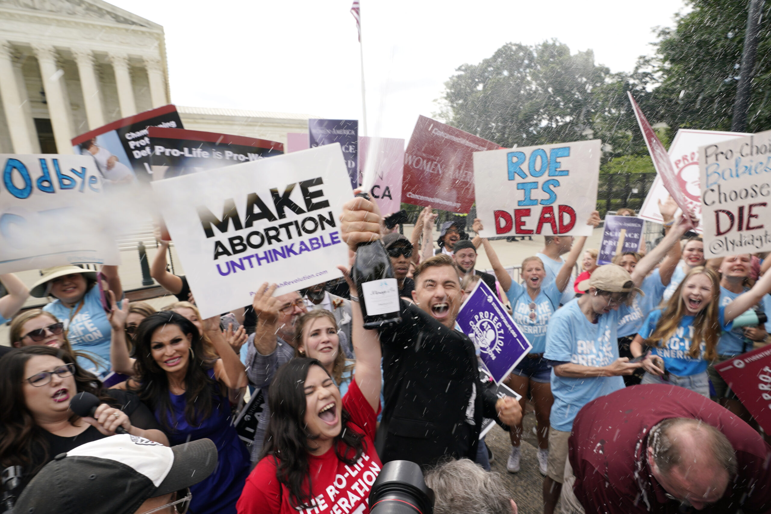 A celebration outside the Supreme Court, Friday, June 24, 2022, in Washington. The Supreme Court has ended constitutional protections for abortion that had been in place nearly 50 years — a decision by its conservative majority to overturn the court's landmark abortion cases. (AP Photo/Steve Helber)
