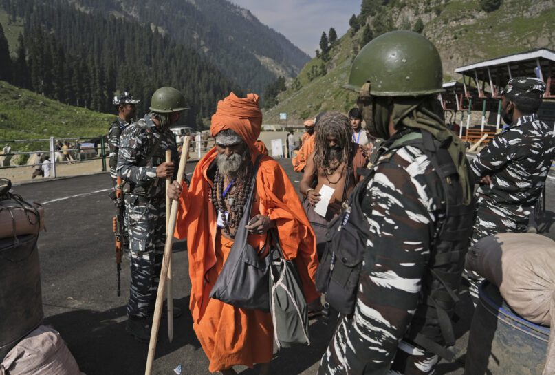 Soldiers stand guard as Hindu devotees begin the Amarnath Yatra annual pilgrimage to to an icy Himalayan cave, in Chandanwari, Pahalgam, south of Srinagar, Indian-controlled Kashmir, Thursday, June 30, 2022. Officials say pilgrims face heightened threat of attacks from rebels fighting against Indian rule and have for the first time tagged devotees with wireless tracking system. They also have deployed drones for surveillance. (AP Photo)