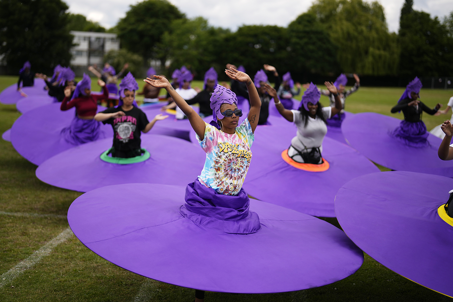 Members of the Mahogany carnival group take part in a rehearsal for their upcoming performance at the Platinum Jubilee Pageant, at Queens Park Community School, in north London, Saturday, May 28, 2022. Britain is getting ready for a party featuring mounted troops, solemn prayers — and a pack of dancing mechanical corgis. The nation will celebrate Queen Elizabeth II’s 70 years on the throne this week with four days of pomp and pageantry in central London. (AP Photo/Matt Dunham)