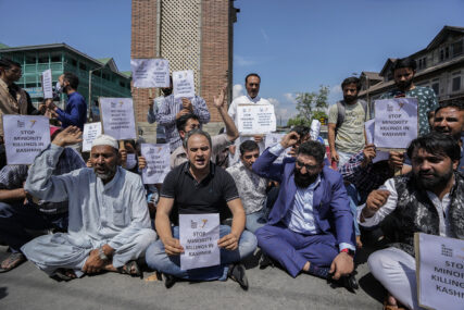 Members of JK Awami Aawaz Party hold placards as they take part in a protest against minority killings, in Srinagar, Indian controlled Kashmir, Thursday, June 2, 2022. Assailants fatally shot a Hindu bank manager in Indian-controlled Kashmir on Thursday, said police, who blamed militants fighting against Indian rule for the attack. (AP Photo/Mukhtar Khan)