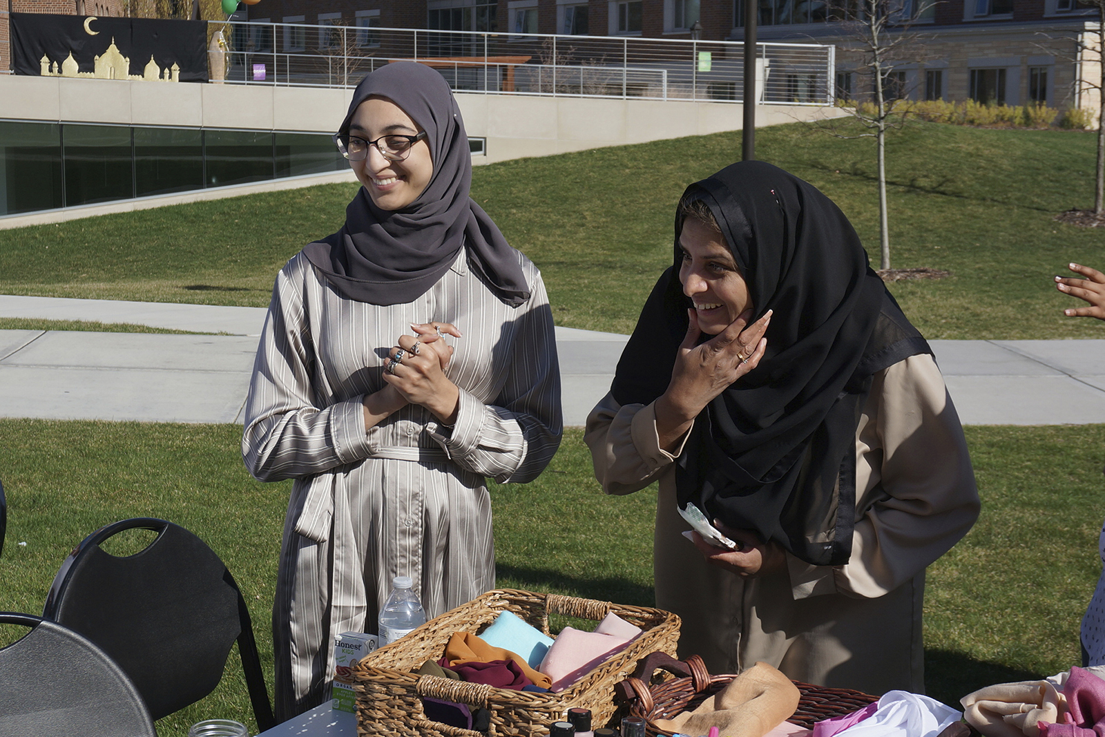 University of St. Thomas graduating senior Salma Nadir, left, and Muslim chaplain Sadaf Shier talk with students attending the school's celebration for the end of the Muslim holy month of Ramadan in St. Paul, Minn., on Saturday, May 7, 2022. Growing numbers of college students across the US are struggling with anxiety and stress, and campus ministry offices are broadening their mission to address the crisis. (AP Photo/Giovanna Dell'Orto)