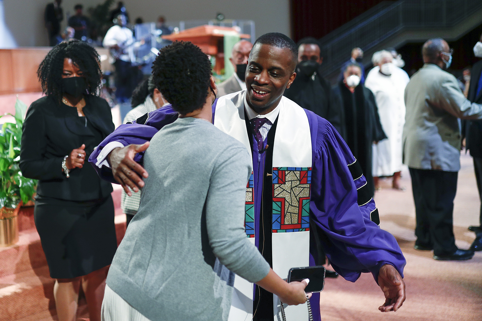 Rev. Dante Quick, greets people as he preaches during a church service at the First Baptist Church of Lincoln Gardens on Sunday, May 22, 2022, in Somerset, N.J. (AP Photo/Eduardo Munoz Alvarez)