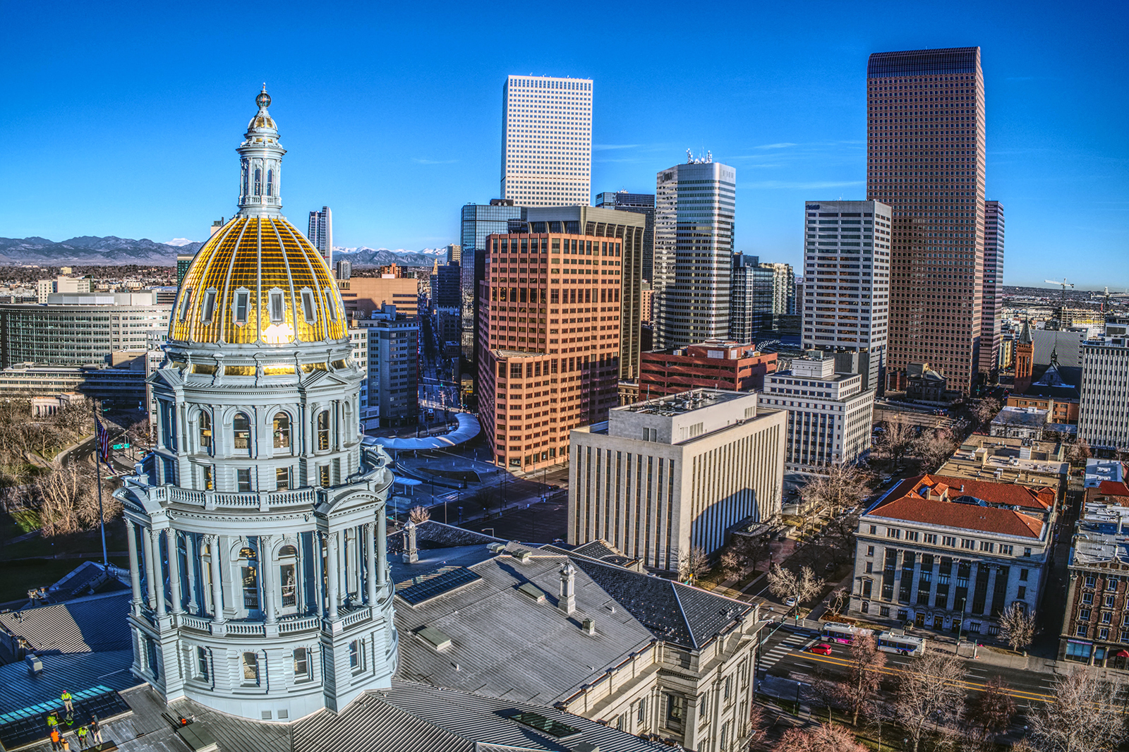 The Colorado Capitol, left, in downtown Denver. Photo by Acton Crawford/Unsplash/Creative Commons