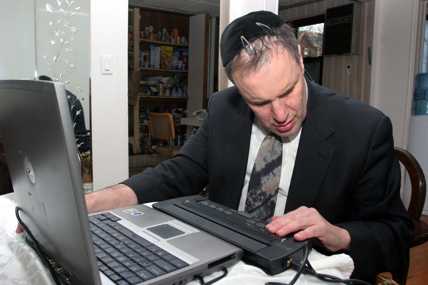 Rabbi Michael Levy works on his computer. Photo courtesy of Levy