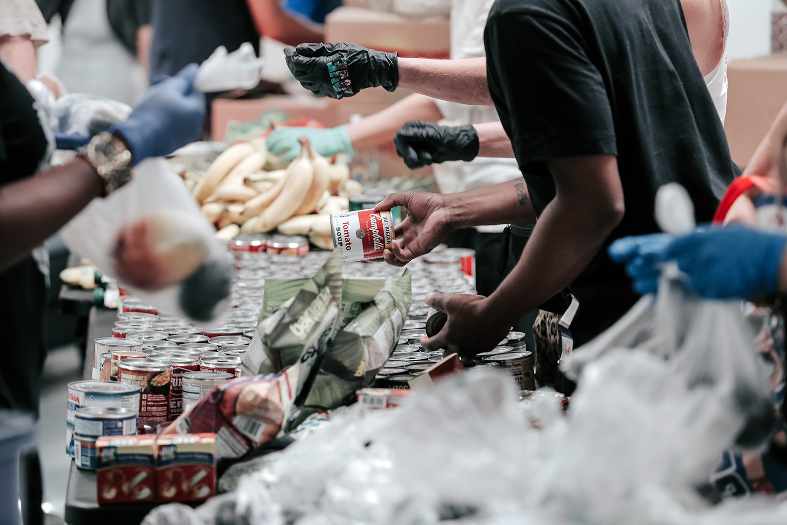 People work together organizing donations at a food bank. Photo by Joel Muniz/Unsplash/Creative Commons