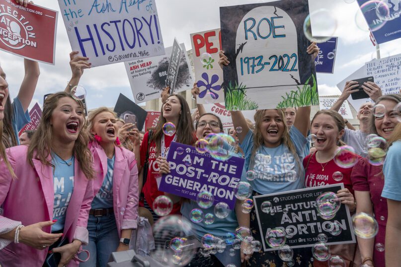 Anti-abortion protesters celebrate following the Supreme Court's decision to overturn Roe v. Wade, the federally protected right to abortion, outside the Supreme Court in Washington, Friday, June 24, 2022. The Supreme Court has ended constitutional protections for abortion that had been in place nearly 50 years, a decision by its conservative majority to overturn the court's landmark abortion cases. (AP Photo/Gemunu Amarasinghe)
