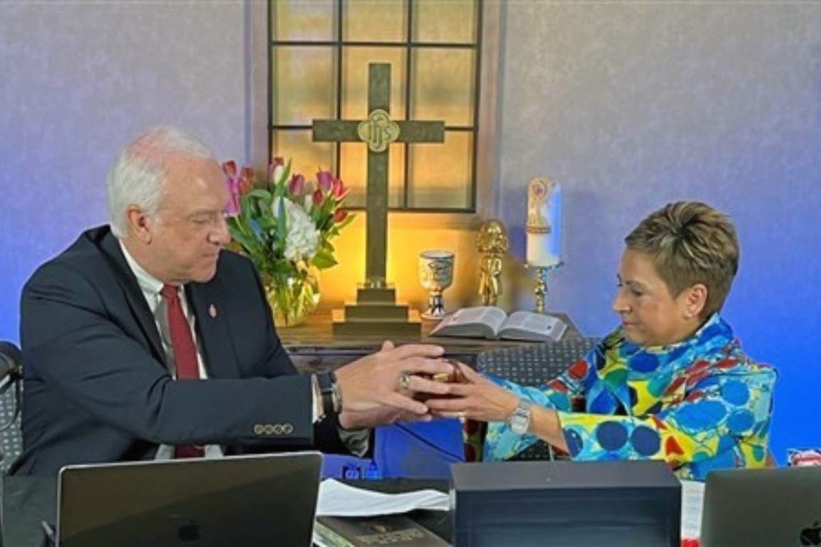 New Council of Bishops President Bishop Thomas J. Bickerton, left, receives the gavel from outgoing President Bishop Cynthia Fierro Harvey during the spring meeting, Friday, April 29, 2022. Photo courtesy of the COB