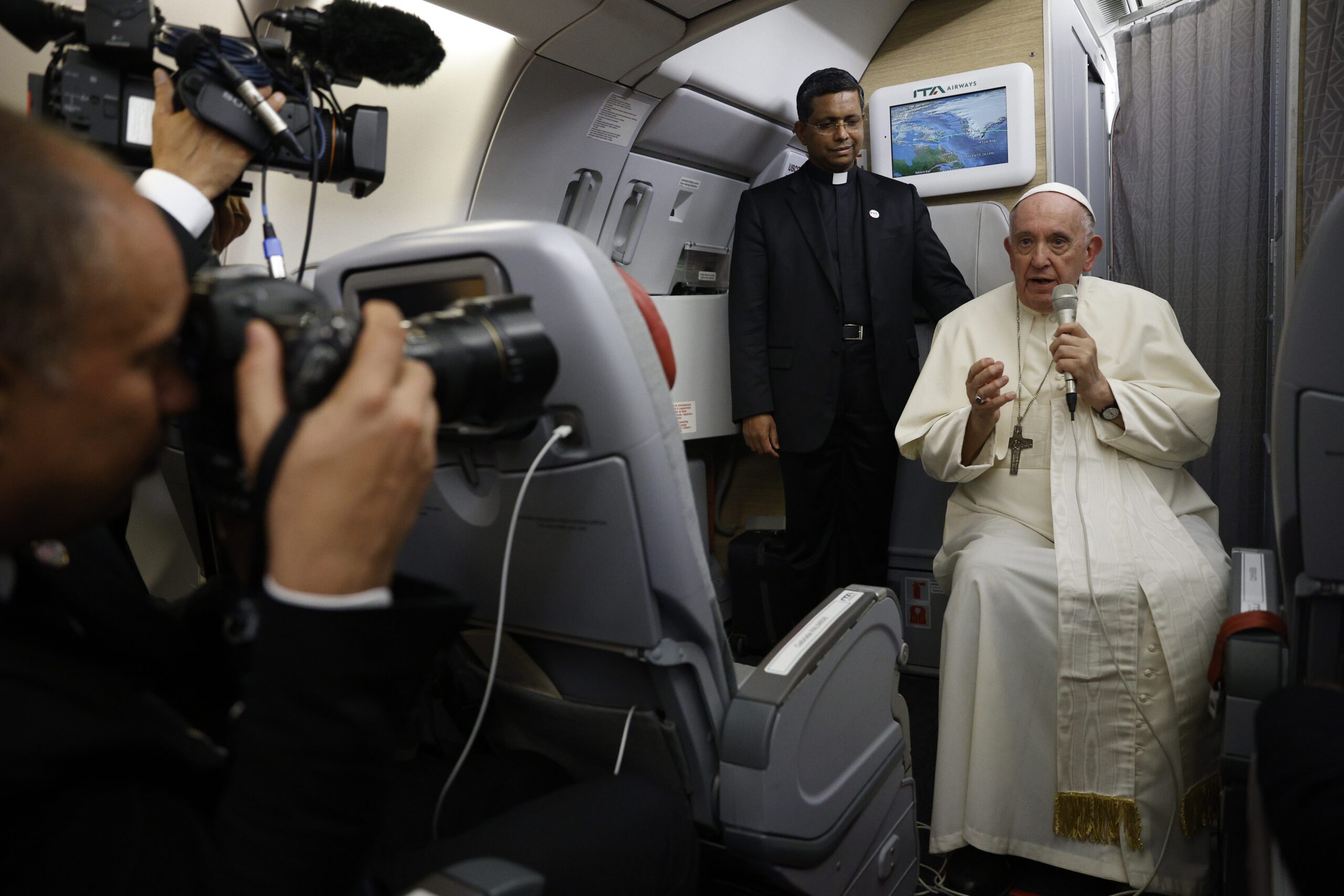 Pope Francis speaks to journalists aboard the papal flight back from Canada, July 30, 2022, where he paid a six-day pastoral visit. Francis wrapped up his Canadian pilgrimage by meeting with Indigenous delegations and visiting Inuit territory in northern Nunavut. In one of his addresses, he assailed the Catholic missionaries who "supported oppressive and unjust policies" against Native peoples in the country's notorious residential schools and vowed to pursue truth and healing. (Guglielmo Mangiapane/ Pool via AP)