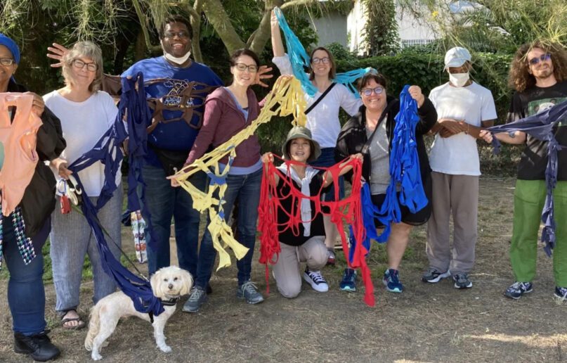 Members of the Beloved Everybody community pose during an art installation project in Los Angeles in May 2022. Photo courtesy of Beloved Everybody