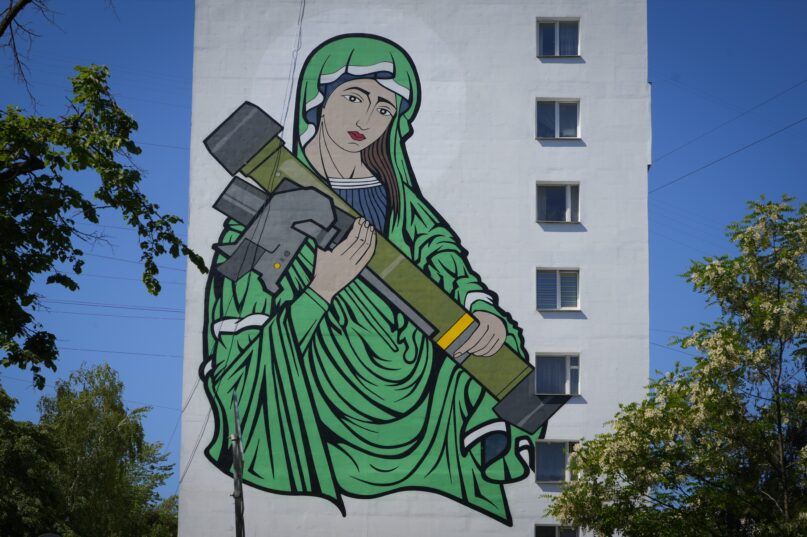A mural in Kyiv depicts the Virgin Mary cradling a U.S.-made anti-tank weapon, a Javelin, which is considered a symbol of Ukraine's defense against Russia. (AP Photo/Efrem Lukatsky)