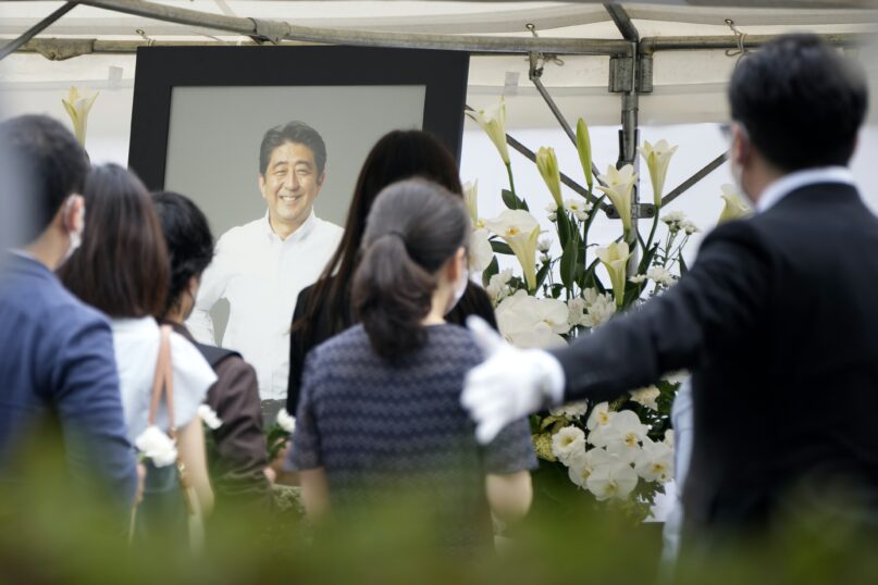 People line up to pay their respects before the funeral of former Prime Minister Shinzo Abe, on July 12, 2022, at Zojoji Temple in Tokyo. (AP Photo/Eugene Hoshiko)
