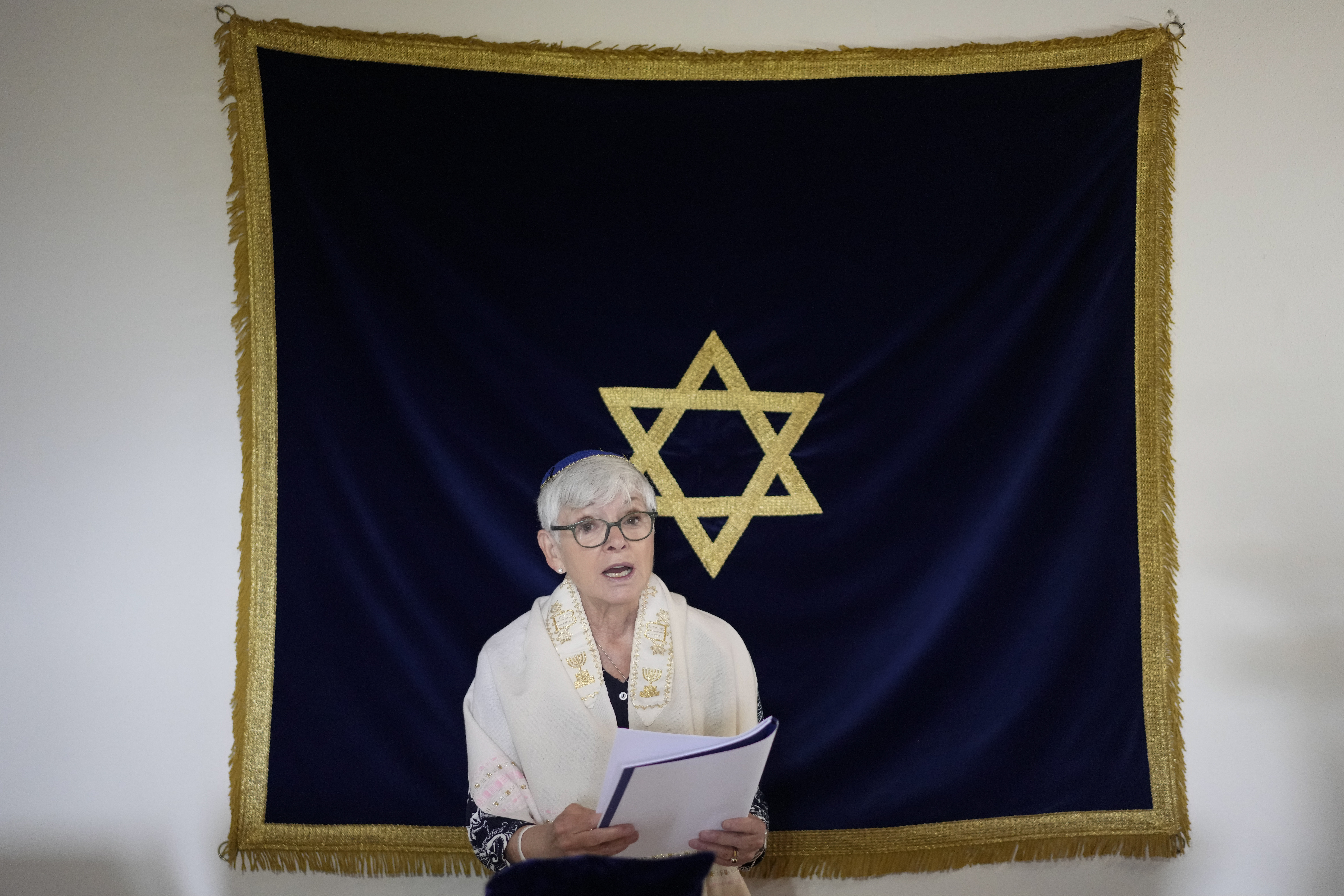 Rabbi Barbara Aiello reads prayers in her 