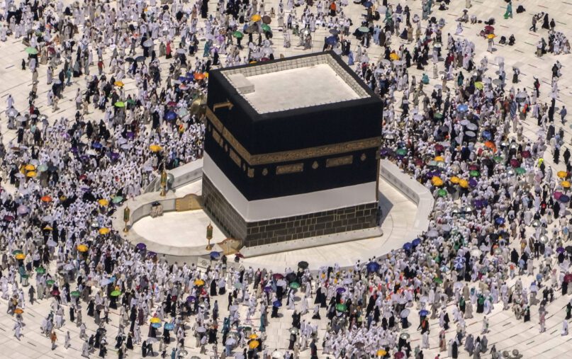 FILE - Muslim pilgrims walk around the Kaaba, the cubic building at the Grand Mosque, during the annual hajj pilgrimage, in Mecca, Saudi Arabia, on July 10, 2022. Police in Mecca say they have arrested a Saudi man who helped an Israeli-Jewish reporter sneak into the city, defying a rule that only Muslims can enter the area that is home to Islam's holiest site. (AP Photo/Amr Nabil, File)
