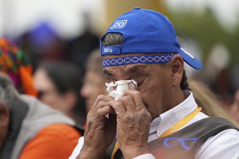 An Indigenous man wipes away tears after Pope Francis delivered his apology to Indigenous people for the church's role in residential schools during a ceremony in Maskwacis, Alberta, as part of his papal visit across Canada on Monday, July 25, 2022. (Nathan Denette/The Canadian Press via AP)