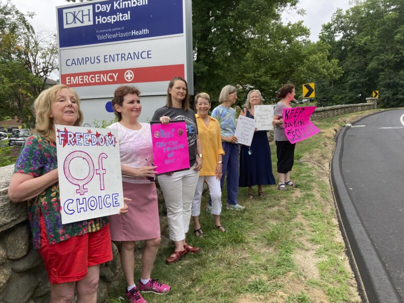 Residents from various communities in mostly rural northeastern Connecticut stage a protest outside Day Kimball Hospital, Monday, July 18, 2022 in Putnam, Conn. The protesters are concerned with Day Kimball Healthcare's plans to affiliate with Covenant Healthcare, a Catholic health system that abides by directives set by the U.S. Conference of Catholic Bishops. (AP Photo/Susan Haigh)