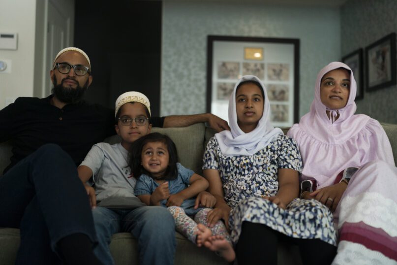 The Zakir family, from left, father Yusuf, son Burhanuddin, Yusuf's niece, Insiya Maimoon; daughter Jumana, mother Fareeda, watch an episode of 
